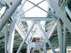 Braced derricks form a "street" through the building