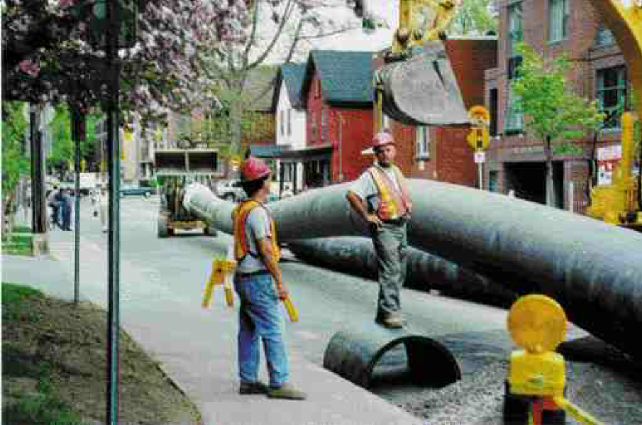 Inserting the HDPE liner pipe on a downtown street.