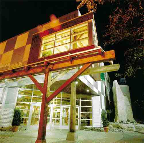 Exterior at night; half the materials are recycled from a building previously on the site.