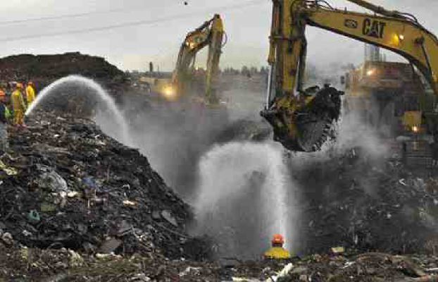 Huge holes were dug around the burning landfill in Delta, B.C., December 1999.