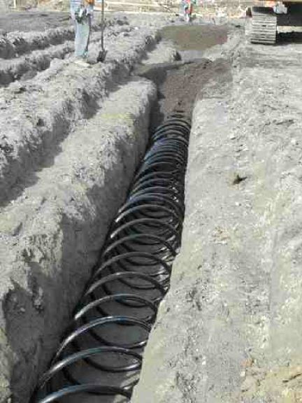 Piping is buried in trenches designed to channel rainwater away from nearby fish spawning streams.