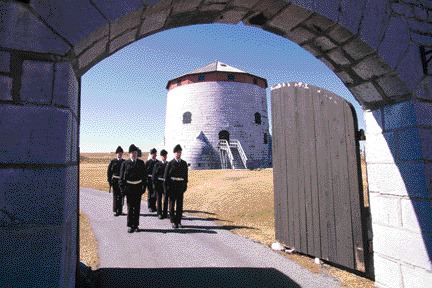 Cadets in period costume parade near the Murney Martello Tower in Kingston, Ontario.