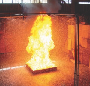 Compressed air foam (CAF) system suppressing a fire in a large, 4.6-m2 pool of heptane, a highly flammable liquid hydrocarbon.