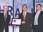 Martin Roy, ing. (centre) receiving his award from the American Society of Heating, Refrigerating and Air-Conditioning Engineers (ASHRAE) in Orlando, Florida.