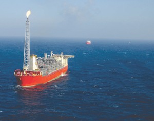 Husky Energy's floating oil production storage and offloading vessel in the White Rose field 350 kilometres east of St. John's, Newfoundland. FPSO SeaRose is configured like a ship so that it can pivot around the bore hole or "tie off" quickly during storms or if icebergs loom. In the background a ship comes to transport the oil to shore.