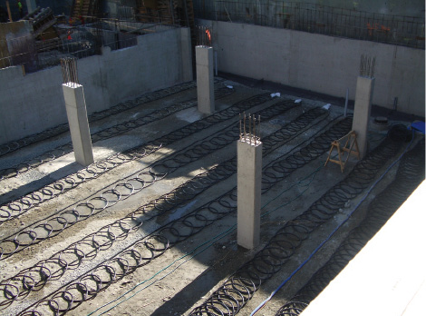An example of a slinky coil geoexchange filed being placed under he parkade of the City of North Vancouver Library in 2007.  Photo by Geoff McDonnell, P.Eng.