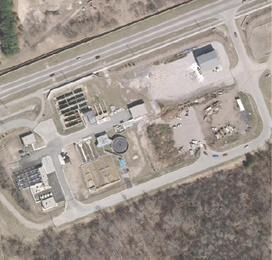 Aerial view of the plant on its constrained site near a busy road and a prestigious golf course.