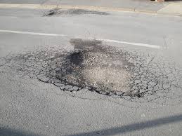 Pothole on a Montreal road. Image; Wikipedia.