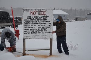 Removing boil water advisory sign